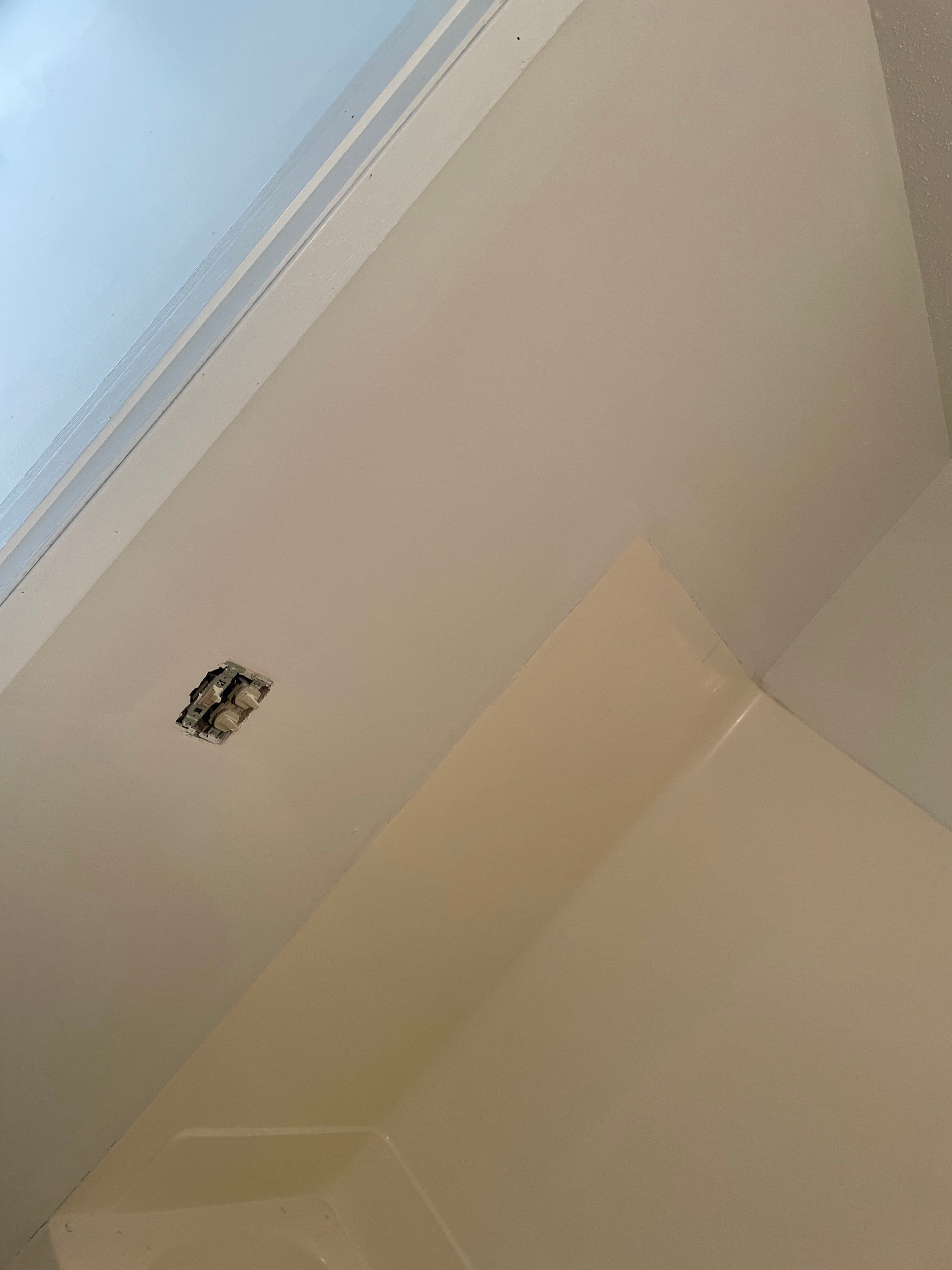 Ceiling damage with mold near a window in a bathroom. Repair and maintenance needed.