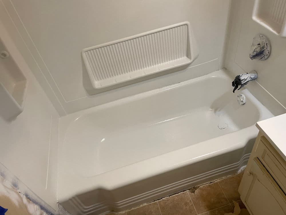 Freshly painted bathtub with a clean, modern design in a bathroom renovation setting.